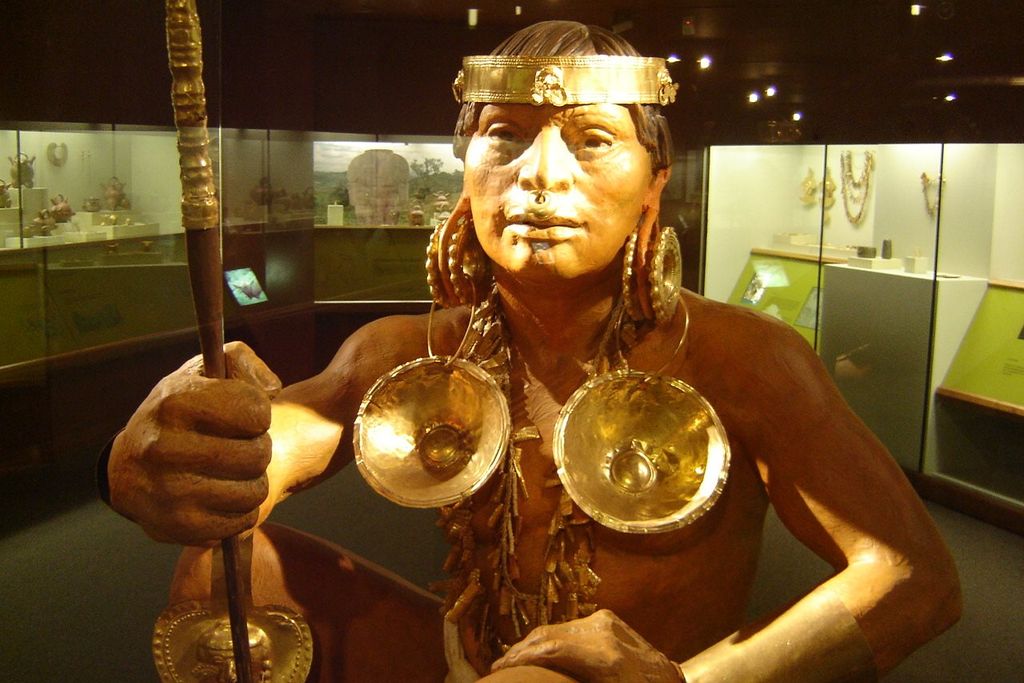 A figure of a man wearing gold accessories in Gold Museum in Bogota, Colombia.