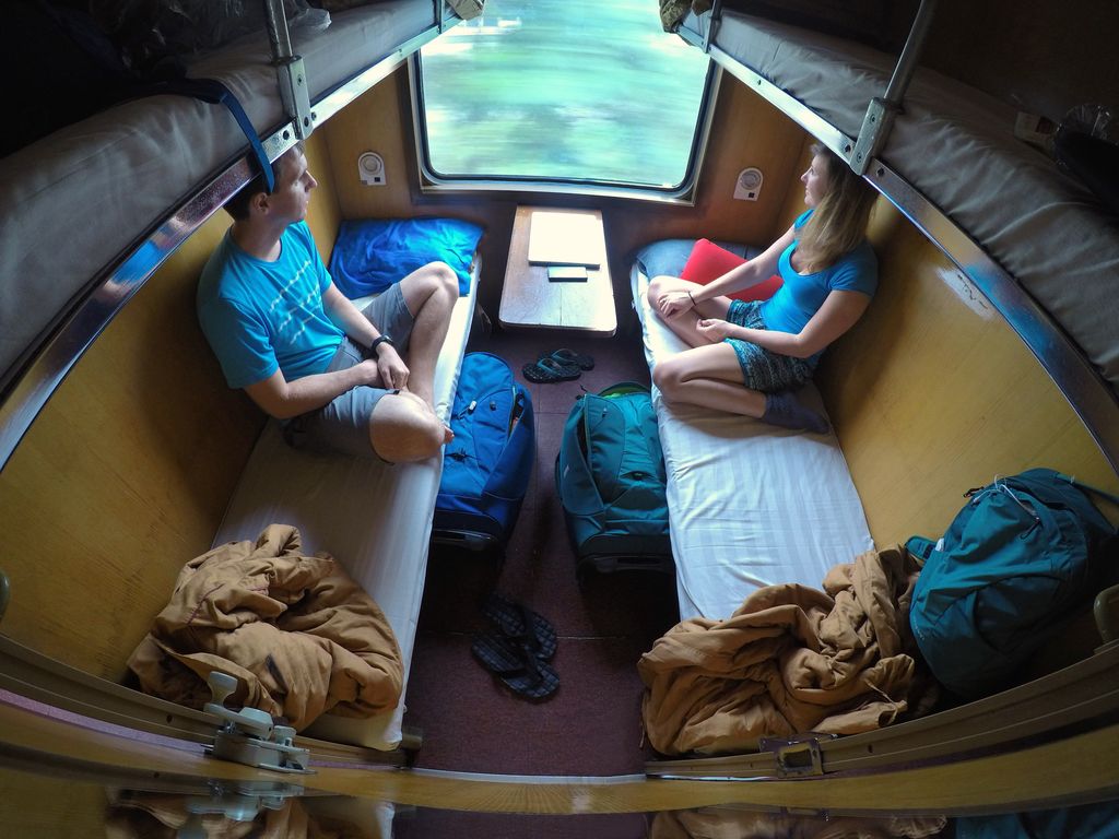 A man and a woman on a sleeper train in Vietnam.